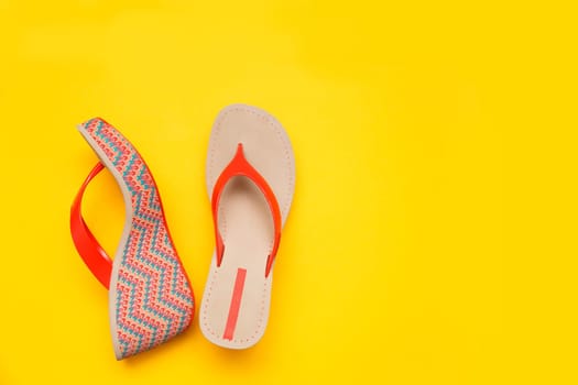 Bright summer women's sandal isolated on yellow background. Top view.