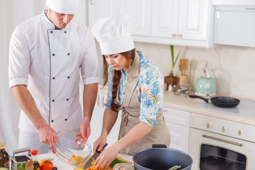 Two chefs are working together.
