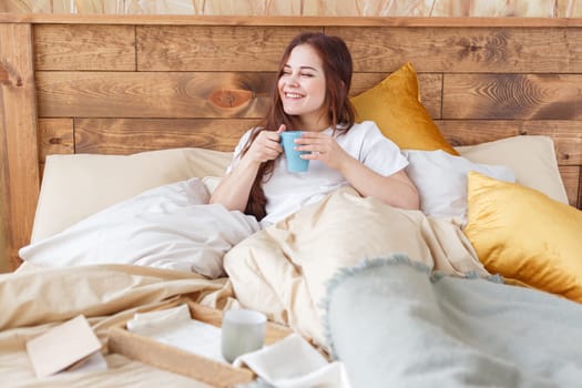 Woman drinking coffee at home or hotel.