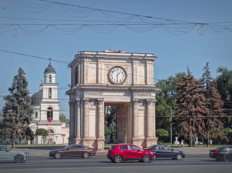 Triumphal Arch and the Metropolitan Cathedral Nativity of the Lord architectural centerpiece of Chisinau city, Moldova. Autumn season view to the landmarks from the Stephen the Great avenue