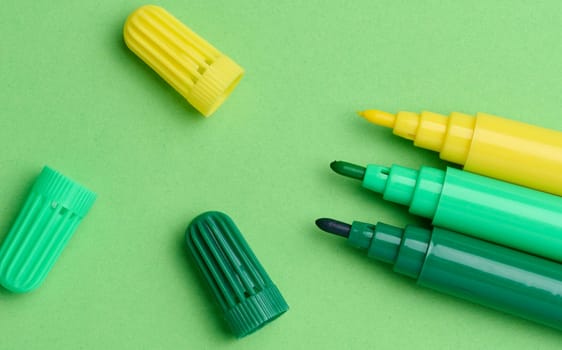 Green and yellow markers on a green background, top view