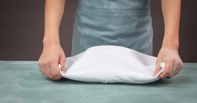 Fresh yeast dough, baker covers bowl with towel for fermentation, bread or pizza, prepare ingredients for food, baking pastry