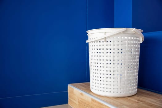 Empty new white plastic laundry clothes basket at convenience store for support customer, Laundromat convenience store, Laundry and housework concept