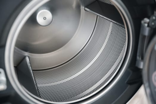 Inside of washing machine tub is made of stainless steel, Close up brand new drum material metal electrical household appliance