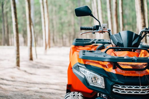 A quadbike competition in the autumn field, with the sun rising and the wheels kicking up mud and dirt, closeup Extreme recreation activity concept