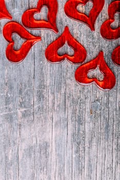 St. Valentine's Day design background card. Red Valentine heart border layout on rustic wooden texture. Abstract love shape top view.