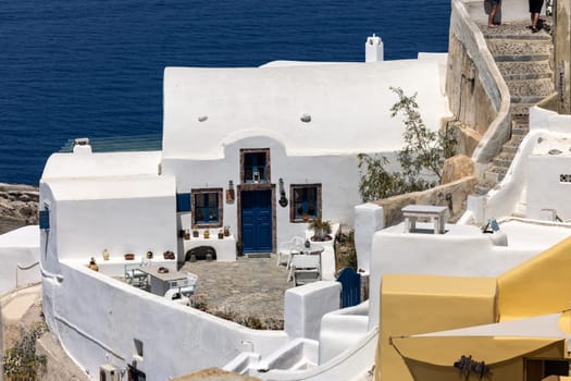 Whitewashed buildings on the edge of the caldera cliff in Oia village, Santorini, Greece