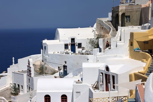 Whitewashed houses with terraces and a beautiful view in Oia on Santorini island, Greece