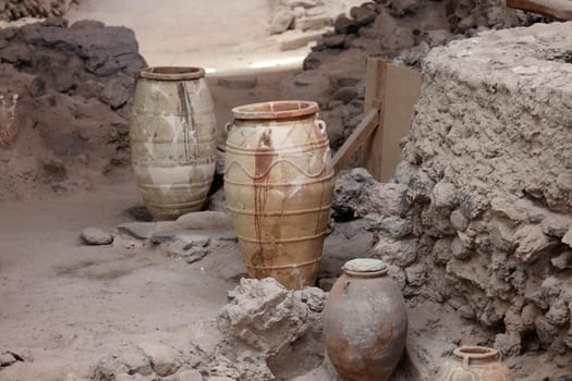 Santorini, Greece - July 01, 2021: Recovered ancient pottery in prehistoric town of Akrotiri, excavation site of a Minoan Bronze Age settlement on the Greek island of Santorini