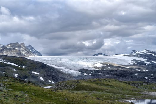 beautiful norwegian landscape with hills and a lake in front