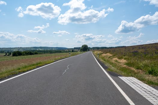 Empty high rhoen road with green nature and blue sky, Bavaria, Germany