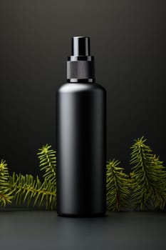black container with a spray bottle on a dark background. strict, laconic packaging for men's cosmetics or perfumes.