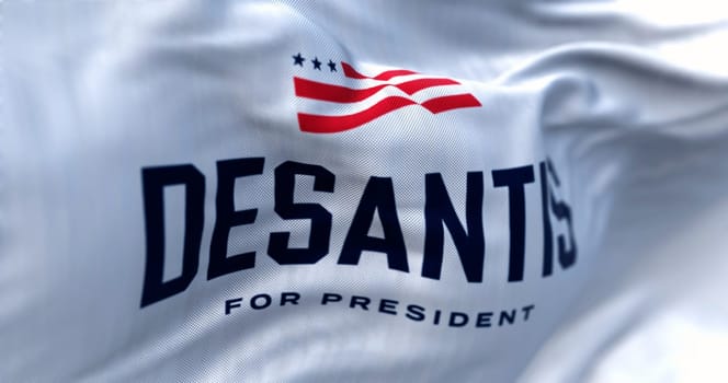 Tallahassee, US, April 28 2023: Ron DeSantis 2024 Republican presidential primaries campaign flag waving. Illustrative editorial 3d illustration render. Selective focus. Rippled background