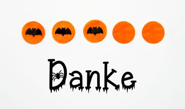 White Halloween Background With Orange Dots And Black Bats And German Text Danke, Which Means Thank You In English