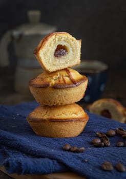 Pasticciotto leccese pastry filled with egg custard cream and sour cherry jam. Whole and half pasticiotties served for typical apulian breakfast with coffee, close up