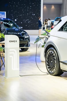 Nonthaburi, Thailand - APR 2, 2023 Electric car and chargers at The 44th Bangkok international motor show 2023 at IMPACT Arena, Muang Thong Thani, Nonthaburi, Thailand.