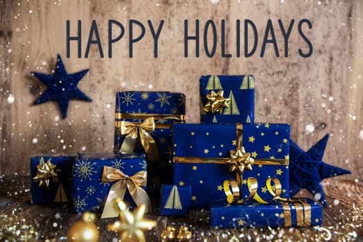 Text Happy Holidays, Wooden Background, Blue Christmas Presents, Snowfall, Gifts And Winter Decoration