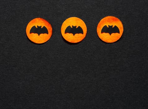Black Halloween Background With Three Orange Dots With Bats And Copyspace