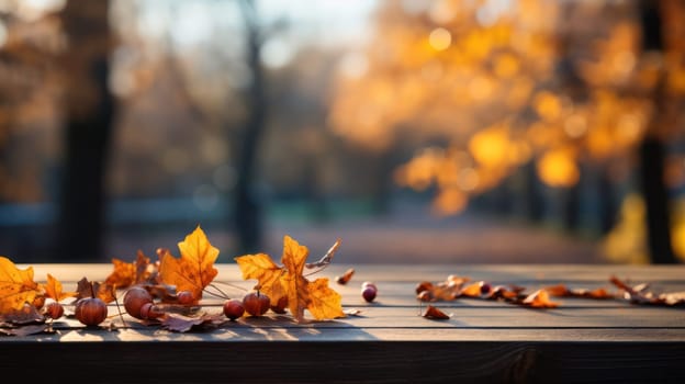 autumn yellow leaves on a wooden table against the background of a blurred image of an autumn landscape on a sunny day