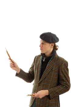 Young smiling artist with a beret on his head on a white background