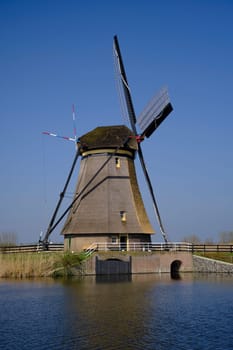 Traveling In The Netherlands. View of Traditional Romantic Dutch Windmills in Kinderdijk Village in the Netherlands Before Sunset. Horizontal Shot
