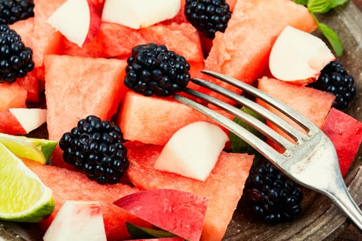 Vitamin salad of watermelon, blackberry and peach. Healthy summer dessert