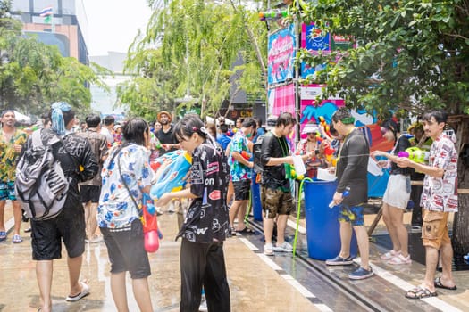 Siam Square, Bangkok, Thailand - APR 13, 2023 Songkran Festival, The short action of people joins celebrations of the Thai New Year or Songkran in Siam Square Bangkok, Thailand.
