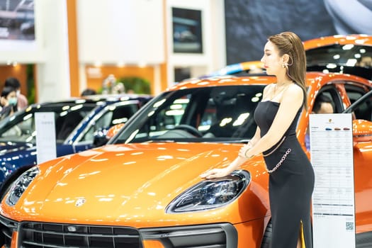 Nonthaburi, Thailand - MAR 26, 2023 Unidentified model poses with a car at The 44th Bangkok international motor show 2023 at IMPACT Arena, Muang Thong Thani, Nonthaburi, Thailand.