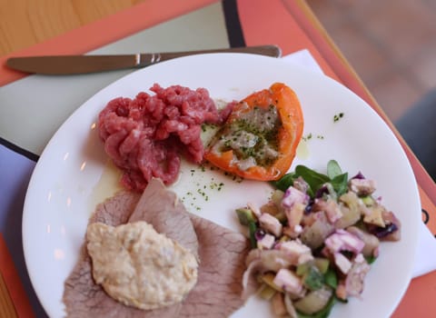 A delicious starter from Piedmont. Steak tartare, carpaccio, stuffed peppers, and salad