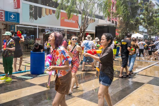 Siam Square, Bangkok, Thailand - APR 13, 2023 Songkran Festival, The short action of people joins celebrations of the Thai New Year or Songkran in Siam Square Bangkok, Thailand.