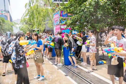Siam Square, Bangkok, Thailand - APR 13, 2023 Songkran Festival, The short action of people joins celebrations of the Thai New Year or Songkran in Siam Square Bangkok, Thailand.