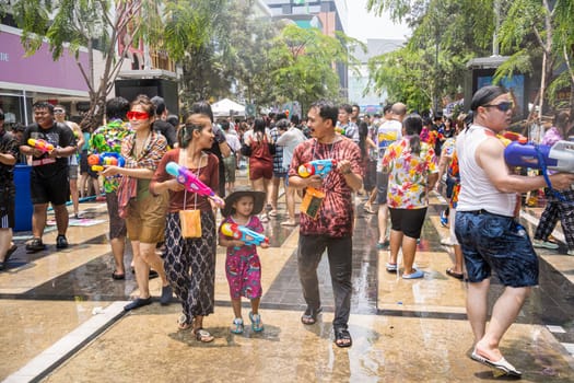 Siam Square, Bangkok, Thailand - APR 13, 2023 Songkran Festival, The short action of people joins celebrations of the Thai New Year or Songkran in Siam Square Bangkok, Thailand.