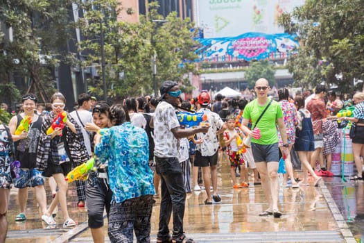 Siam Square, Bangkok, Thailand - APR 13, 2023 Songkran Festival, The short action of people joins celebrations of the Thai New Year or Songkran in Siam Square Bangkok, Thailand.