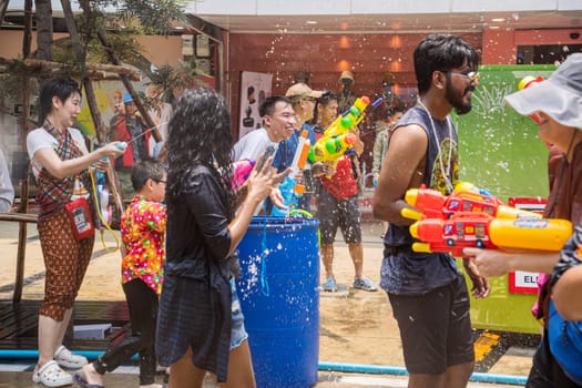 Siam Square, Bangkok, Thailand - APR 13, 2023 Songkran Festival, The short action of people joins celebrations of the Thai New Year or Songkran in Siam Square Bangkok, Thailand.