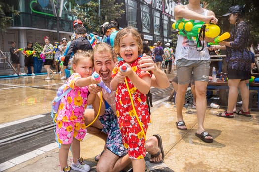 Siam Square, Bangkok, Thailand - APR 13, 2023 Songkran Festival, The short action of people joins celebrations of the Thai New Year or Songkran in Siam Square Bangkok, Thailand.