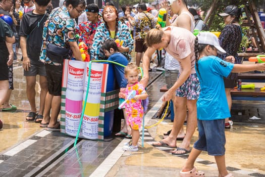 Siam Square, Bangkok, Thailand - APR 13, 2023 Songkran Festival, The short action of people joins celebrations of the Thai New Year or Songkran in Siam Square Bangkok, Thailand.