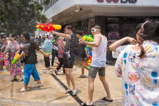 Siam Square, Bangkok, Thailand - APR 13, 2023 Songkran Festival, The short action of people joins celebrations of the Thai New Year or Songkran in Siam Square Bangkok, Thailand.