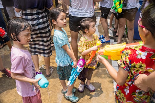 Siam Square, Bangkok, Thailand - APR 13, 2023 Songkran Festival, The short action of people joins celebrations of the Thai New Year or Songkran in Siam Square Bangkok, Thailand.