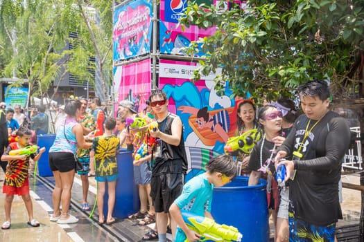 Siam Square, Bangkok, Thailand - APR 13, 2023 Songkran Festival, The short action of people joins celebrations of the Thai New Year or Songkran in Siam Square Bangkok, Thailand.