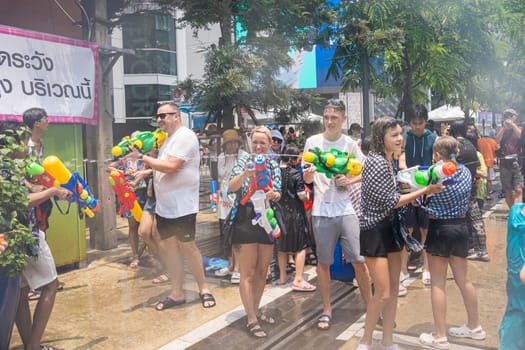 Siam Square, Bangkok, Thailand - APR 13, 2023 Songkran Festival, The short action of people joins celebrations of the Thai New Year or Songkran in Siam Square Bangkok, Thailand.