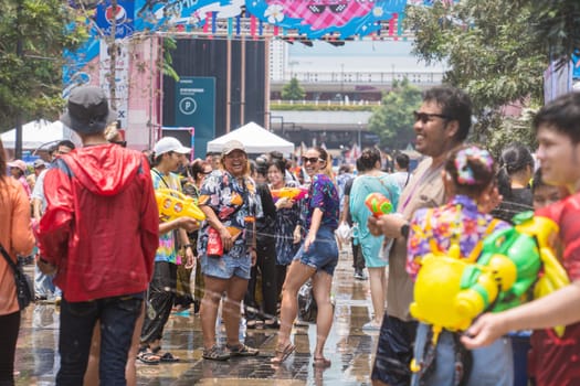 Siam Square, Bangkok, Thailand - APR 13, 2023 Songkran Festival, The short action of people joins celebrations of the Thai New Year or Songkran in Siam Square Bangkok, Thailand.