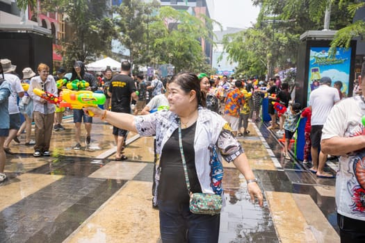 Siam Square, Bangkok, Thailand - APR 13, 2023 Songkran Festival, The short action of people joins celebrations of the Thai New Year or Songkran in Siam Square Bangkok, Thailand.