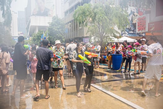 Siam Square, Bangkok, Thailand - APR 13, 2023 Songkran Festival, The short action of people joins celebrations of the Thai New Year or Songkran in Siam Square Bangkok, Thailand.
