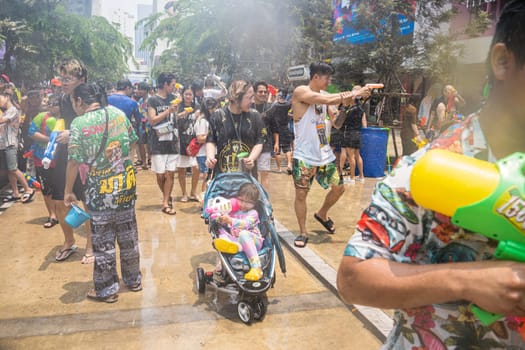 Siam Square, Bangkok, Thailand - APR 13, 2023 Songkran Festival, The short action of people joins celebrations of the Thai New Year or Songkran in Siam Square Bangkok, Thailand.