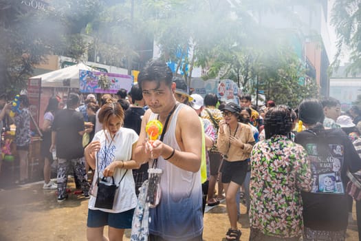 Siam Square, Bangkok, Thailand - APR 13, 2023 Songkran Festival, The short action of people joins celebrations of the Thai New Year or Songkran in Siam Square Bangkok, Thailand.