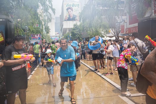 Siam Square, Bangkok, Thailand - APR 13, 2023 Songkran Festival, The short action of people joins celebrations of the Thai New Year or Songkran in Siam Square Bangkok, Thailand.