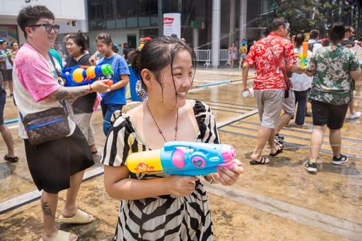 Siam Square, Bangkok, Thailand - APR 13, 2023 Songkran Festival, The short action of people joins celebrations of the Thai New Year or Songkran in Siam Square Bangkok, Thailand.
