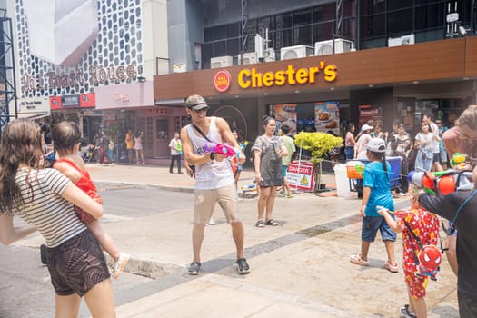 Siam Square, Bangkok, Thailand - APR 13, 2023 Songkran Festival, The short action of people joins celebrations of the Thai New Year or Songkran in Siam Square Bangkok, Thailand.