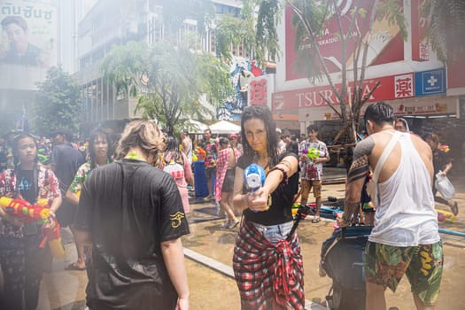 Siam Square, Bangkok, Thailand - APR 13, 2023 Songkran Festival, The short action of people joins celebrations of the Thai New Year or Songkran in Siam Square Bangkok, Thailand.