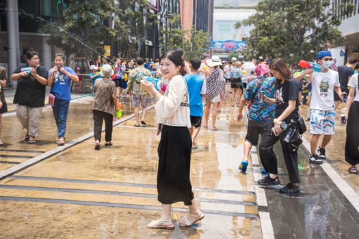Siam Square, Bangkok, Thailand - APR 13, 2023 Songkran Festival, The short action of people joins celebrations of the Thai New Year or Songkran in Siam Square Bangkok, Thailand.